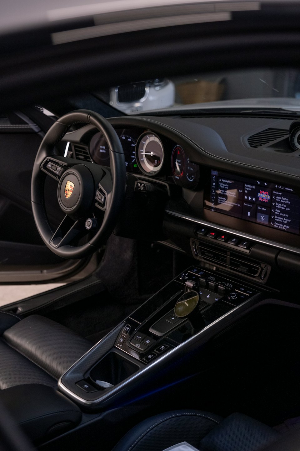 Dashboard and steering wheel of a luxury car interior.